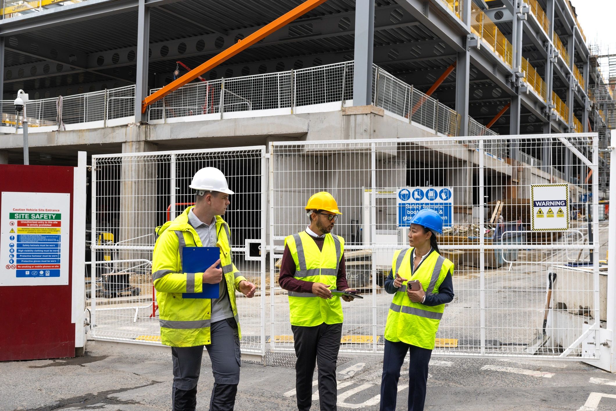Construction project team reviewing plans at a public construction site